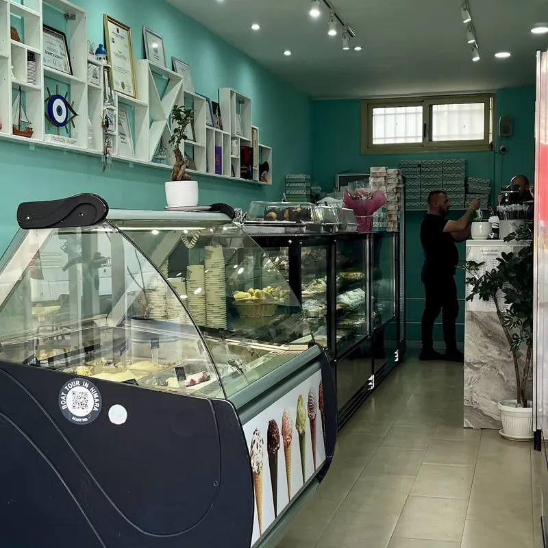 Inside the café: mint walls, white shelves and the gelato and pastry counters