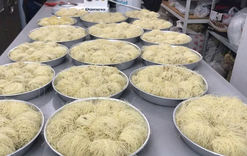Round trays of kadaif on the kitchen table